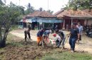 Warga bersama Camat Cikulur M. Iwan Arsiwan dan Kapolsek Cikulur AKP Mulyadi turun langsung melakukan kerja bakti memperbaiki aliran air di sekitar badan jalan, Minggu (4/10/2026).