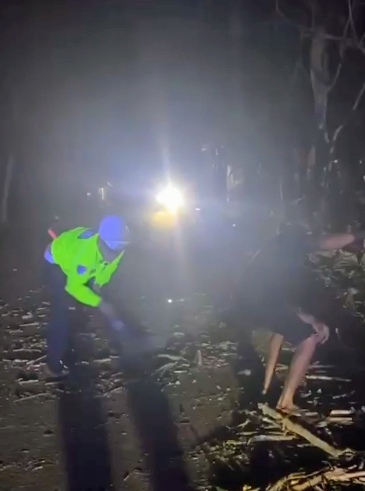 Anggota Satlantas Polres Lebak bersama warga mengevakuasi pohon lapuk yang tumbang dan menutup badan Jalan Nasional Rangkasbitung-Cipanas di wilayah Narimbang, Kabupaten Lebak, Banten, Jumat (23/10/2026) malam.